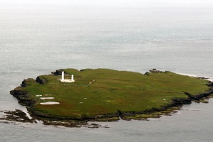 Pentland Skerries island with lighthouse - between Scottish mainland and Orkney islands